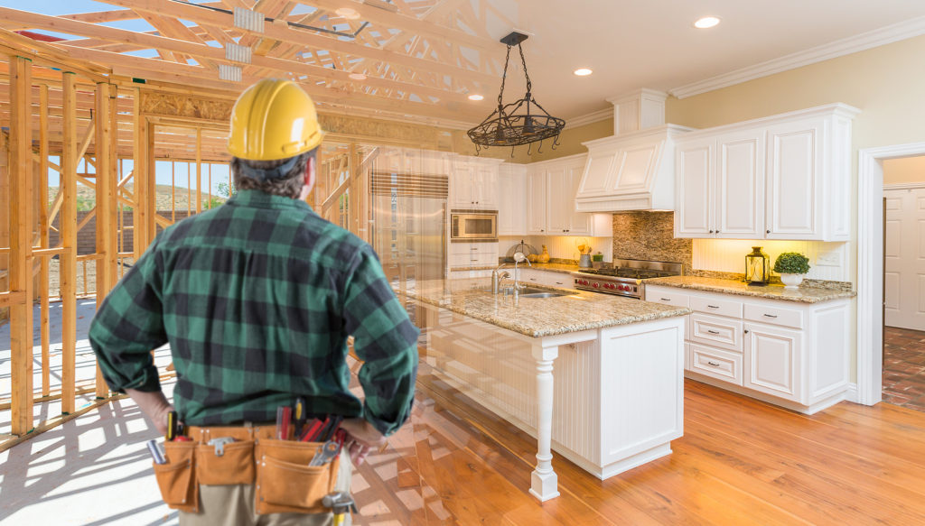 contractor standing in front custom kitchen construction framing