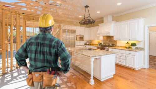 contractor standing in front custom kitchen construction framing