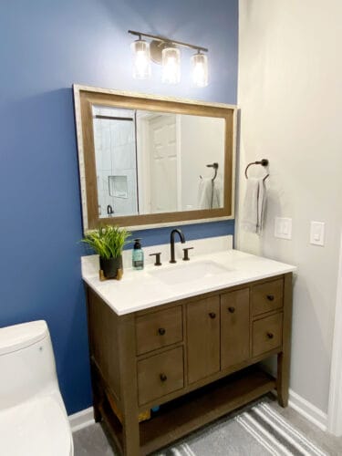 bathroom remodel with brown freestanding vanity