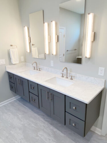 bathroom remodel with floating vanity and led sconces
