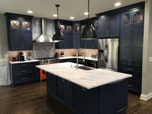 kitchen remodel with bold blue cabinets and orange range