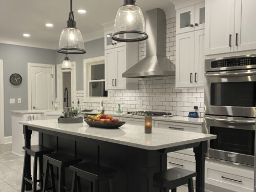 kitchen remodel with white cabinets and black island