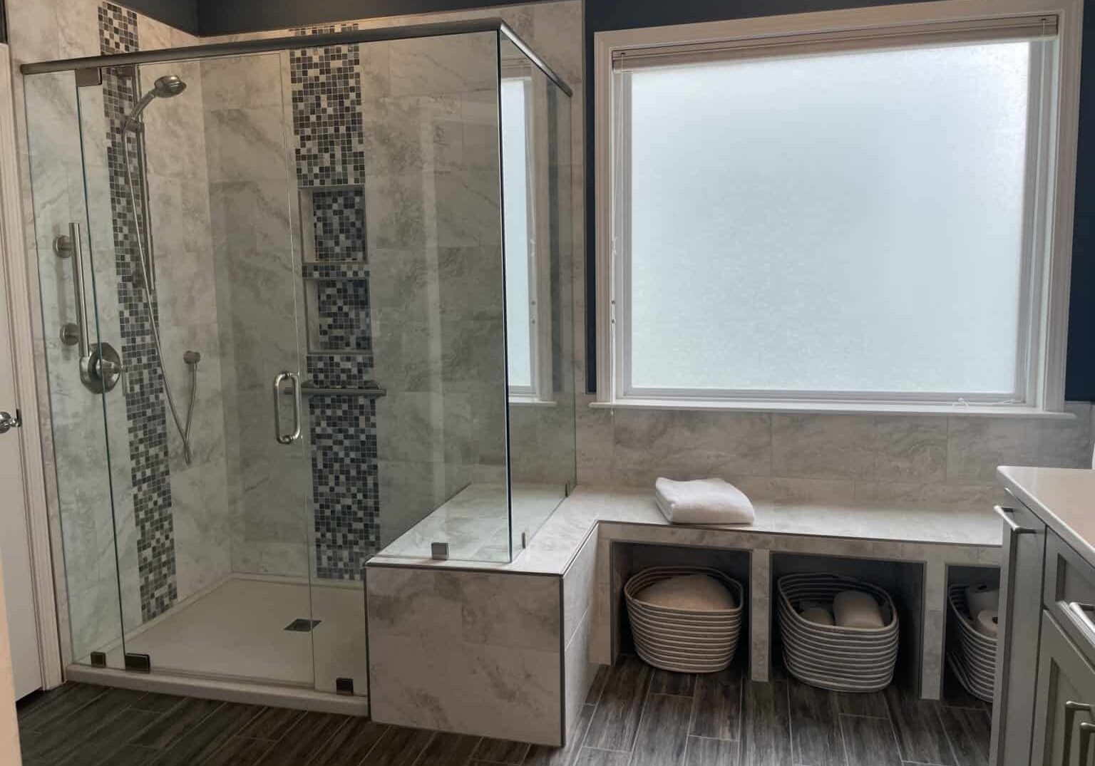 bathroom remodel with accent tile columns and tiled bench