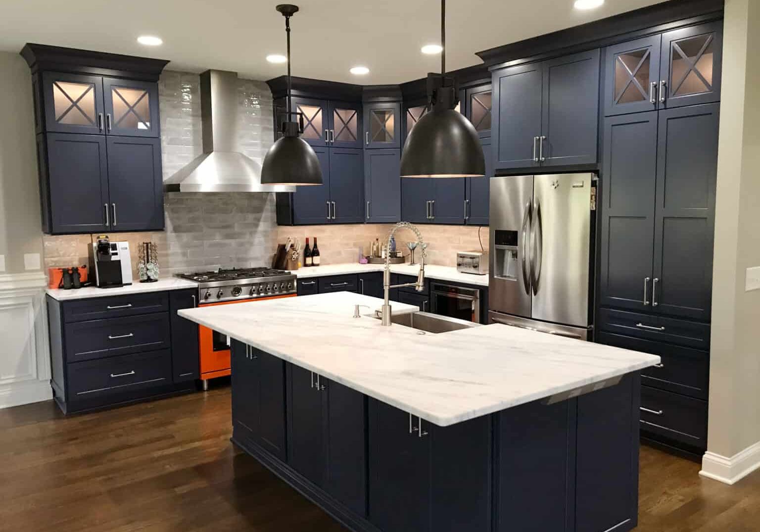kitchen remodel with bold blue cabinets and orange range
