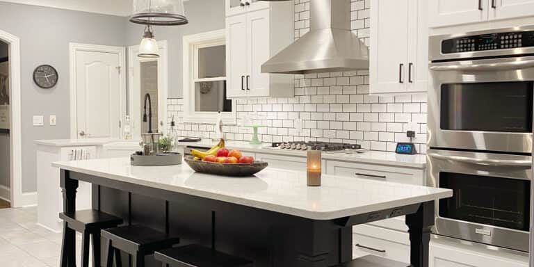 kitchen remodel with white cabinets and black island