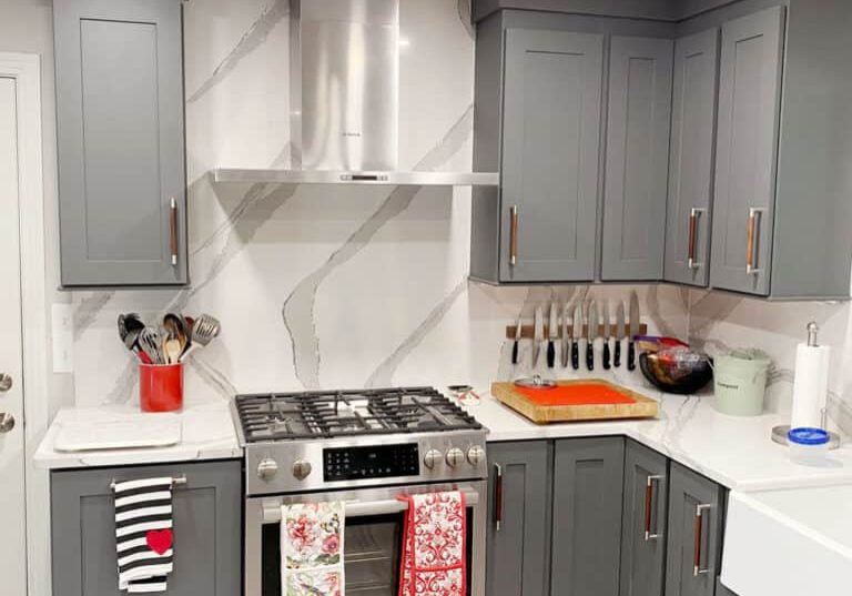 old hickory kitchen remodel with dark gray cabinets and full height quartz backsplash