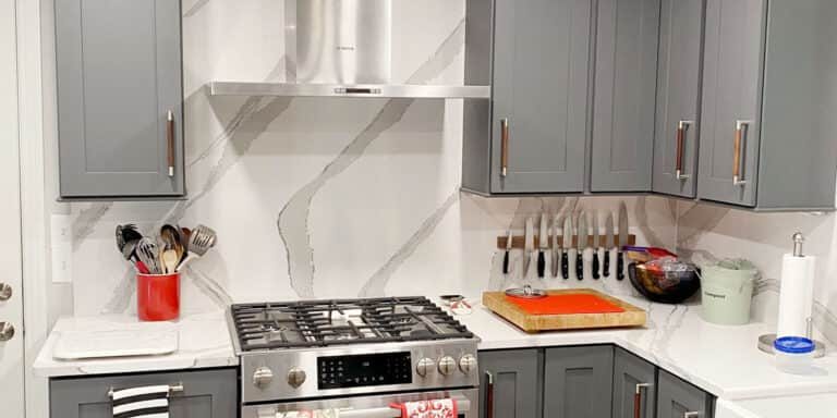 old hickory kitchen remodel with dark gray cabinets and full height quartz backsplash