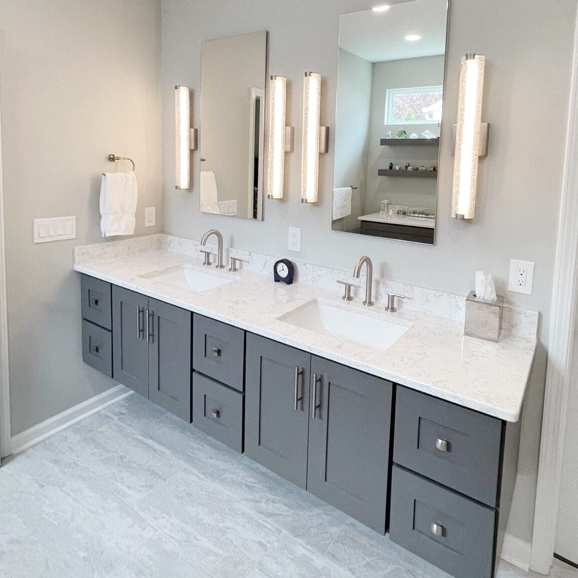 bathroom remodel with floating vanity and powered medicine cabinets