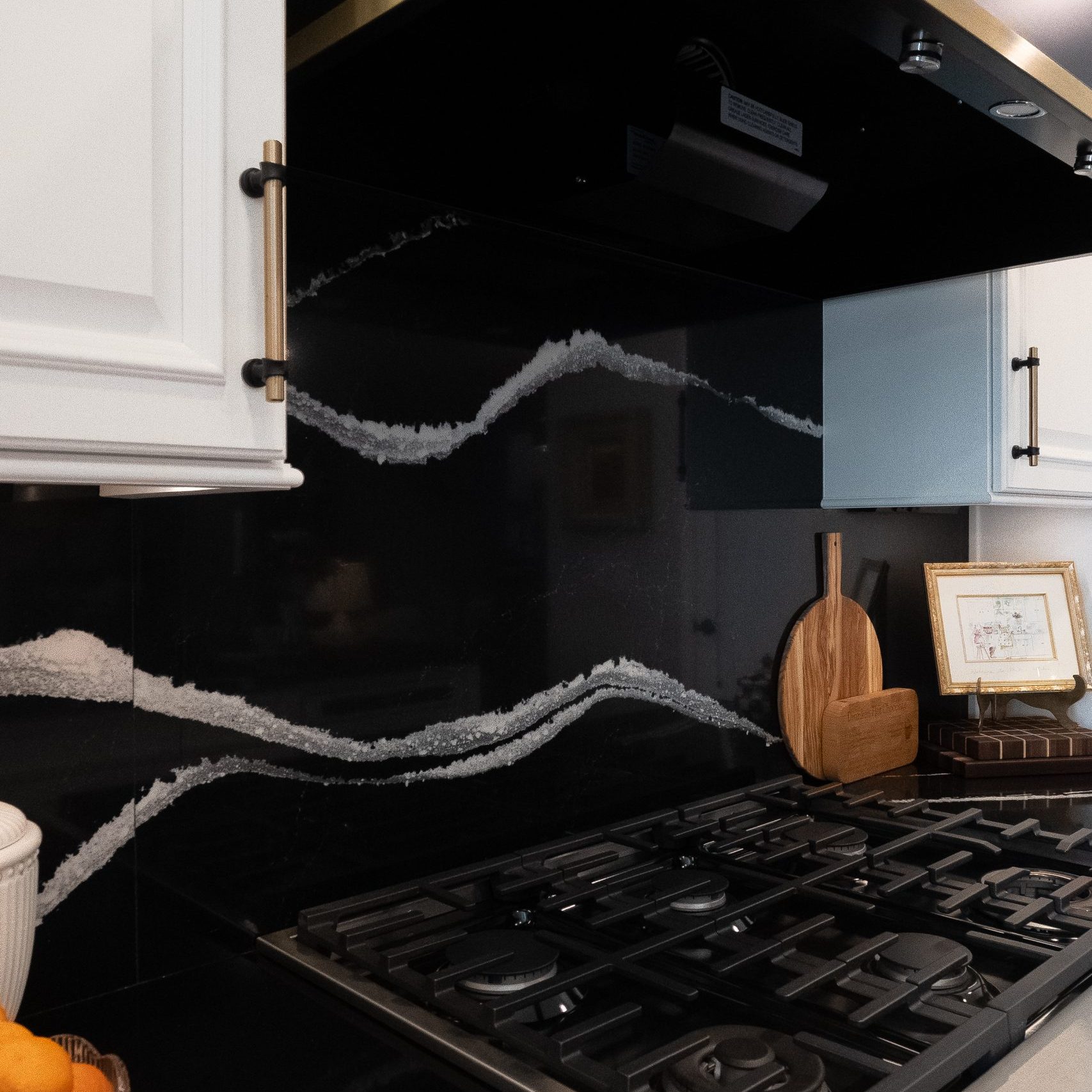 Kitchen Remodel with black quartz backsplash and white veining